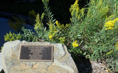 Memorials and lush landscaping along walkways adorn this Nature Walk.