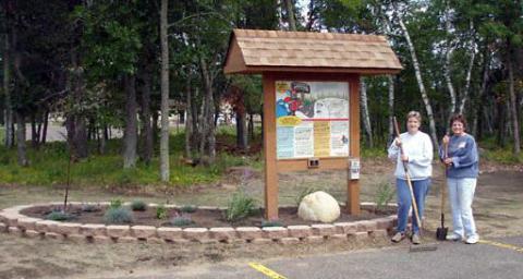 Breezy Point Byway kiosk site is landscaped by Master Gardener Wini Kristufek and 'helper' Diane Williams.