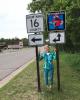 Scenic Byway board member, Lynn Scharenbroich stands beside new route signage installed this spring along the Scenic Byway county roads.